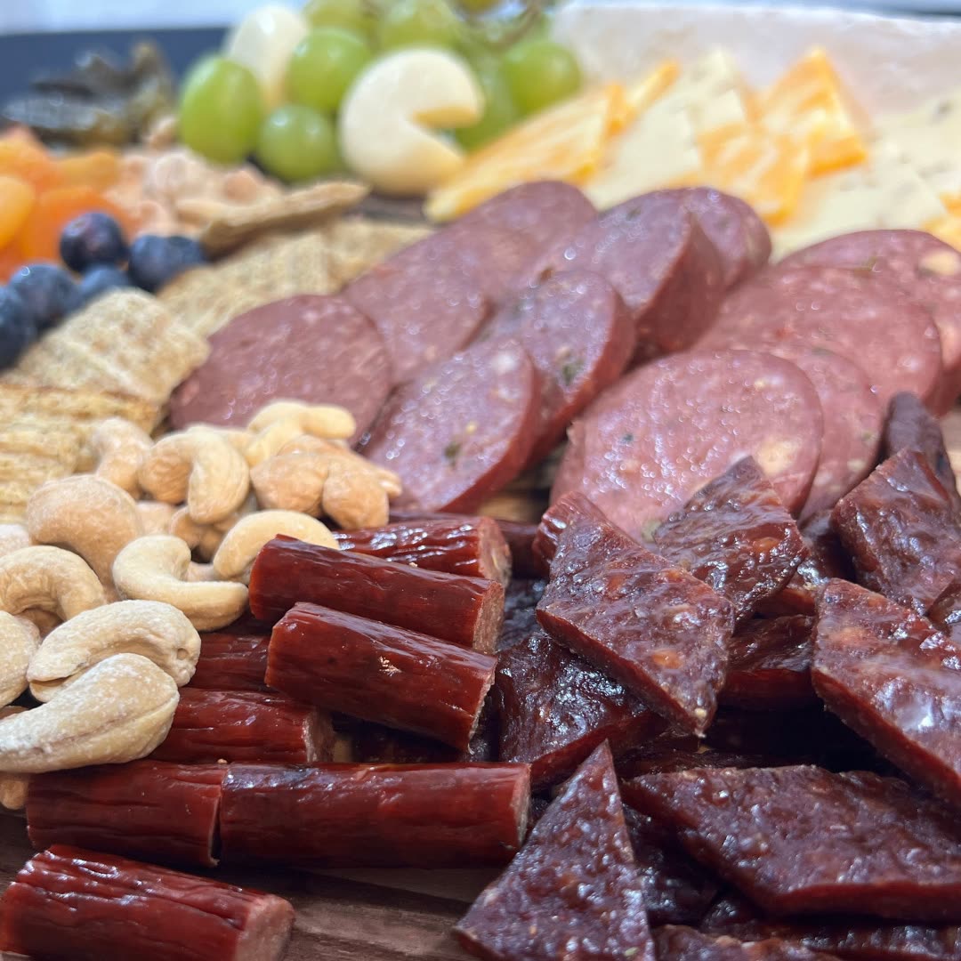 Thousand Hills summer sausage, snack sticks and jerky on a board
